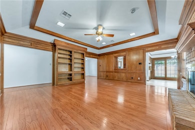 Unfurnished living room featuring a ceiling fan, a