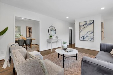 Living room featuring dark wood finished floors, recessed lighting, and baseboards