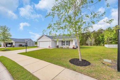 Single story home with a front lawn, fence, a gara