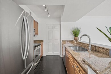 Stylish and Functional Kitchen. Granite countertops, stainless steel appliances, and wood cabinetry make this kitchen perfect for cooking and entertaining.