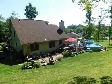 Rear of home with fire pit and small Koi pond