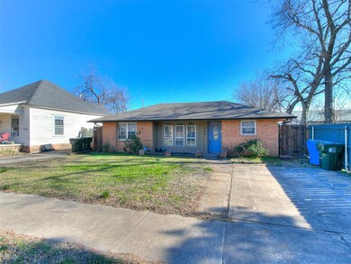 Ranch-style home featuring a front lawn