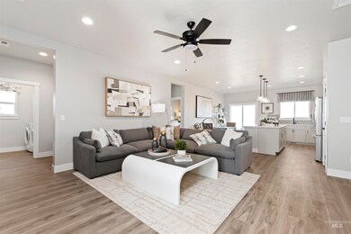 Living area with light wood finished floors, recessed lighting, and ceiling fan