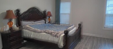 Bedroom with hardwood / wood-style flooring