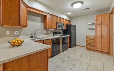 Fully equipped kitchen with gas stove, over the range microwave, plenty of cabinetry and quartz countertops.