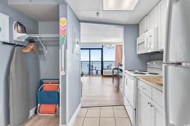 Kitchen with light countertops, an inviting chande