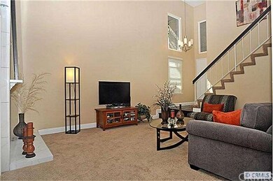 View of soaring ceilings in living area. Upgraded 