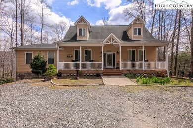A covered front porch welcomes you from the large, circular driveway.