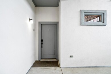 Entrance to property with stucco siding