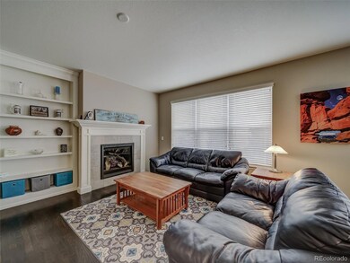 Family room with built-in shelves and fan and TV p