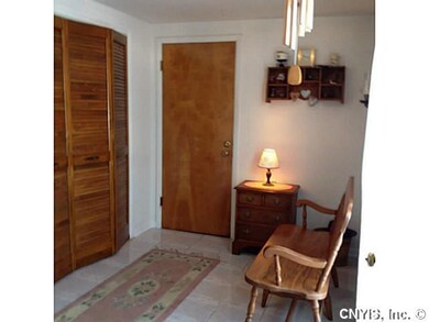 Foyer. Tiled mudroom with closet and entrance to g