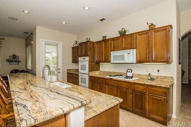 Medium maple cabinets with granite counters and un