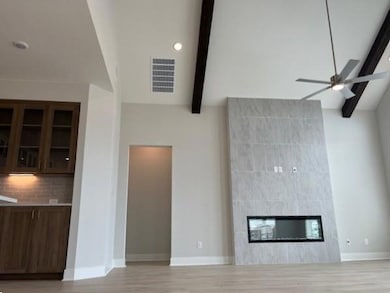 Unfurnished living room featuring ceiling fan, a 