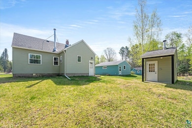 Rear view of house with a lawn