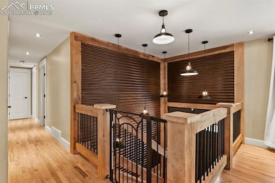 Hall featuring baseboards, recessed lighting, wood
