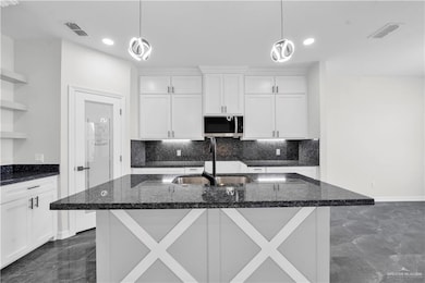 Kitchen with open shelves, decorative backsplash, white cabinetry, decorative light fixtures, and recessed lighting