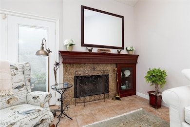 Living room featuring tile patterned floors, a til
