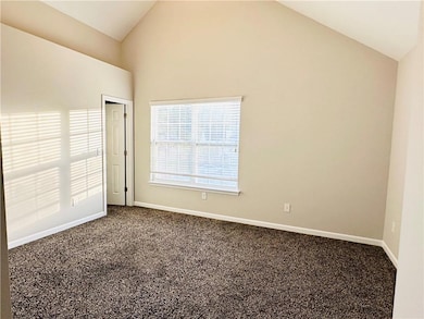 Unfurnished room with high vaulted ceiling, basebo