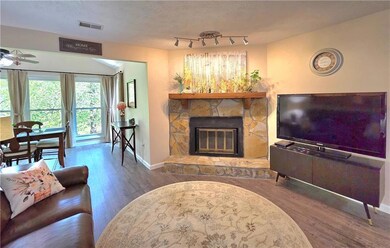 Living room with wood finished floors, visible ven