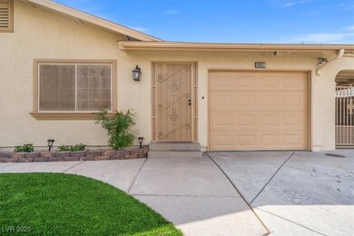 View of exterior entry with a garage, driveway, an