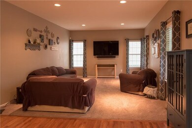 The open kitchen sits opposite this cozy carpeted 