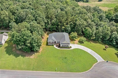 Aerial view of property's location featuring a forest