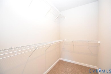 Spacious closet with light colored carpet