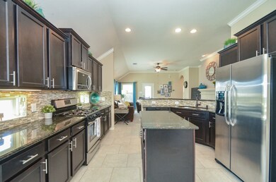 Beautiful kitchen with island, stainless steel appliances and hardware.