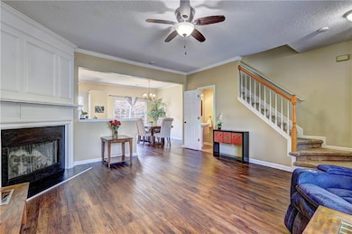 Living room featuring wood finished floors, stairw