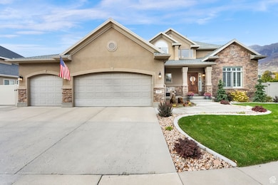 View of front of house featuring stone siding, stucco siding, concrete driveway, and an attached garage