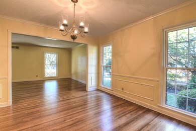 Gleaming wood floors reflect the character of this