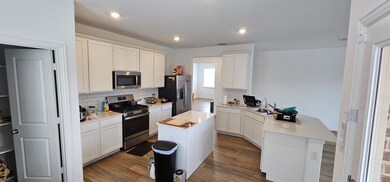 Kitchen featuring a peninsula, a sink, light count