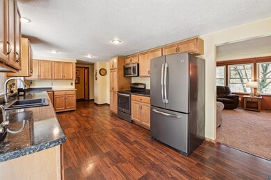 Kitchen featuring stainless steel appliances, dark