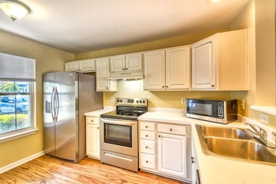 Kitchen with a sink, stainless steel appliances, u
