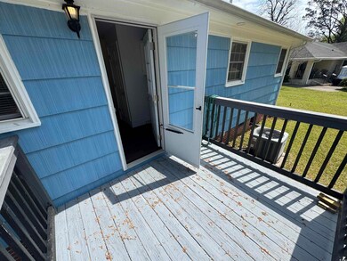 Wooden deck with cooling unit and a lawn