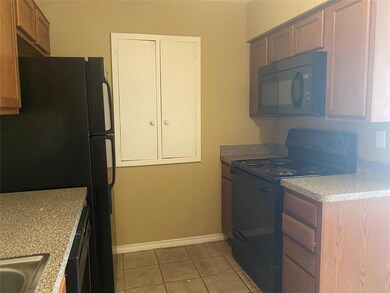 Kitchen featuring light tile patterned flooring, l