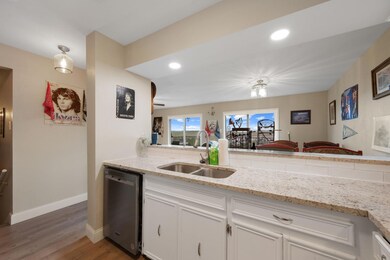 Kitchen featuring dishwasher, wood finished floor