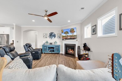 Living room featuring ceiling fan, light wood-type