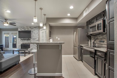 Kitchen featuring visible vents, a kitchen breakfa