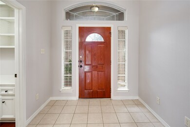 Foyer entrance featuring light tile patterned floo