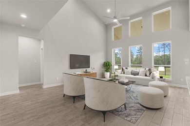 Gather the family and guests together in your lovely living room! Featuring soaring high ceilings, recessed lighting, dark stained ceiling fan, custom paint, gorgeous floors and large windows that provide plenty of natural lighting throughout the day.

