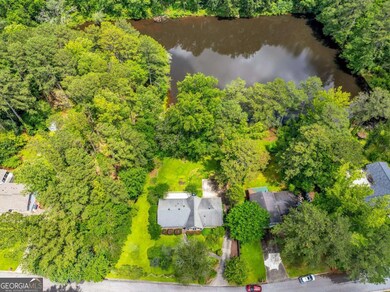 As you can see, there is no development on the opposite side of the lake . The adjacent area to left, almost to the neighbor's driveway, is part of this property. That area has a fence along the property line.