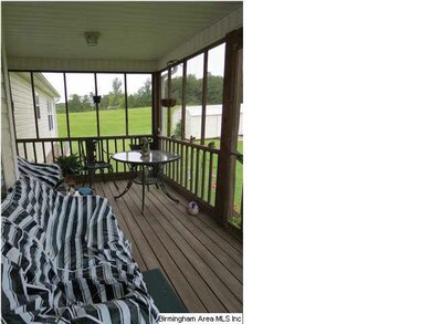 Screened in back deck overlooking private backyard