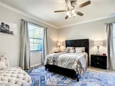 Bedroom with ornamental molding and a ceiling fan