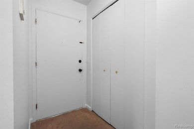 Doorway to outside with carpet floors and baseboards