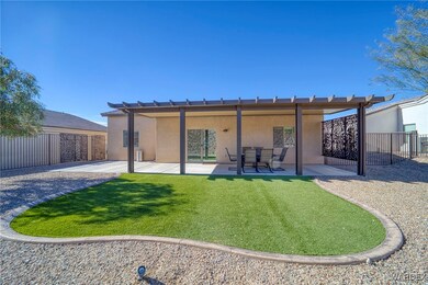 Back of house featuring a yard and a patio area