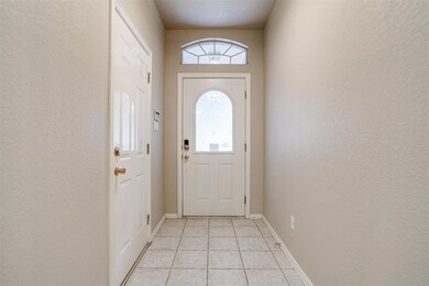 Doorway to outside with light tile patterned flooring