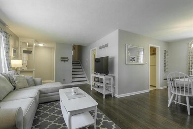 Living room and adjacent dining area make for easy