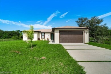 View of front of property featuring a garage, driv