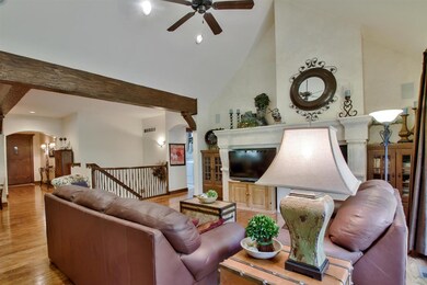 Beamed ceilings and windows all along the back of 